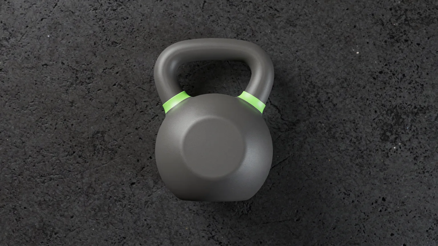 Overhead view of a single plain graphite kettlebell on a dark concrete floor with a volt-green band around the handle